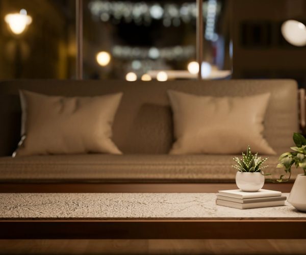 Books and pot plant on marble top table in front of a wooden sofa chair in a dimly lit living room. Cosy Interior, 3D rendering, 3D Illustration.